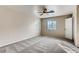 Spacious bedroom with modern ceiling fan, plush carpet, and natural light from the two windows at 447 Temple Canyon Pl, Henderson, NV 89074