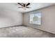 Spacious bedroom featuring plush carpet and a view of the front yard at 447 Temple Canyon Pl, Henderson, NV 89074
