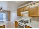 Bright kitchen featuring wooden cabinets and an oven at 447 Temple Canyon Pl, Henderson, NV 89074