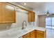 Kitchen with bright counter tops, light wood cabinetry and tile flooring at 447 Temple Canyon Pl, Henderson, NV 89074