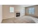 Bright living room with a tile fireplace and large windows at 447 Temple Canyon Pl, Henderson, NV 89074
