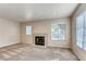 Living room featuring plush carpet, neutral walls, and a cozy fireplace at 447 Temple Canyon Pl, Henderson, NV 89074