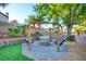 Backyard with a charming swing set, a fire pit, and well-maintained landscaping in a tranquil setting at 4517 Inez Dr, Las Vegas, NV 89130