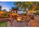 Backyard lounge area featuring a wooden pergola, a fire pit, and comfortable swing seating at 4517 Inez Dr, Las Vegas, NV 89130