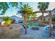 Spacious backyard showcasing a swing set, an outdoor dining area, and mature palm trees at 4517 Inez Dr, Las Vegas, NV 89130