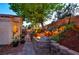 Backyard oasis featuring a stone waterfall feature, fire pit, and lush greenery at 4517 Inez Dr, Las Vegas, NV 89130