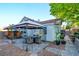 Outdoor dining area with a covered patio, views of lush landscaping, and a charming walkway at 4517 Inez Dr, Las Vegas, NV 89130