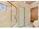 Bathroom featuring a tiled shower with glass doors and a small window at 4517 Inez Dr, Las Vegas, NV 89130