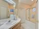 Bright bathroom features a dual-sink vanity, tiled floors, and enclosed shower at 4517 Inez Dr, Las Vegas, NV 89130
