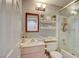 Bathroom with a decorative mirror, vanity, and tiled shower with glass doors at 4517 Inez Dr, Las Vegas, NV 89130