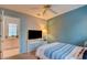Comfortable bedroom featuring a ceiling fan, accent wall, and tiled adjoining room at 4517 Inez Dr, Las Vegas, NV 89130