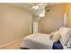 This bedroom features plush carpet, a lighted ceiling fan, and a king bed with soft, neutral decor at 4517 Inez Dr, Las Vegas, NV 89130