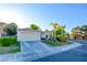 Charming single-story home featuring a tiled roof and mature palm trees at 4517 Inez Dr, Las Vegas, NV 89130