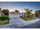 Charming single-story home featuring a tiled roof and mature palm trees at 4517 Inez Dr, Las Vegas, NV 89130