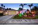 Beautiful home with palm trees, lush grass, and landscape lighting at 4517 Inez Dr, Las Vegas, NV 89130