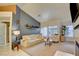 Bright living room with contemporary decor, fireplace, large windows, and comfortable seating at 4517 Inez Dr, Las Vegas, NV 89130
