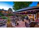 Enchanting outdoor patio with decorative lighting, comfortable seating, and beautiful potted plants at 4517 Inez Dr, Las Vegas, NV 89130