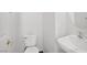 Simple powder room featuring a white sink and a modern toilet, with clean and functional design at 5135 Paradise Valley Ave, Las Vegas, NV 89156