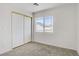 Clean bedroom with a closet, window, and neutral carpet, for a peaceful living space at 5135 Paradise Valley Ave, Las Vegas, NV 89156