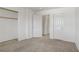 Spacious bedroom with neutral carpet, closet space, and doorway with access to the bathroom at 5135 Paradise Valley Ave, Las Vegas, NV 89156