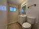 Bathroom features tiled walk-in shower, vanity, commode, and a window for natural light at 5324 Holmby Ave, Las Vegas, NV 89146