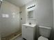 Bathroom features a tiled walk-in shower, vanity, and commode at 5324 Holmby Ave, Las Vegas, NV 89146