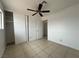 Bedroom features tile flooring, a sliding closet door, and neutral colored walls at 5324 Holmby Ave, Las Vegas, NV 89146