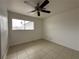 Bedroom features tile flooring, a ceiling fan, and a window at 5324 Holmby Ave, Las Vegas, NV 89146
