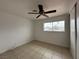 Bedroom features tile flooring, a ceiling fan, a window, and sliding door closet at 5324 Holmby Ave, Las Vegas, NV 89146
