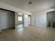 Spacious bedroom boasts tile flooring, mirrored closet doors, and an adjacent bathroom for convenience at 5324 Holmby Ave, Las Vegas, NV 89146