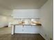Eat-in kitchen bar looking into a large and open living room and kitchen space at 5324 Holmby Ave, Las Vegas, NV 89146