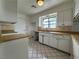 Eat-in kitchen with white cabinets, wood countertops and tile flooring at 5324 Holmby Ave, Las Vegas, NV 89146
