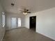 Bright living room featuring tile flooring, a ceiling fan, and access to the backyard through glass patio doors at 5324 Holmby Ave, Las Vegas, NV 89146