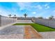 Spacious backyard features artificial turf, gravel landscaping, a stepping stone path, and privacy walls at 6405 Strongbow Dr, Las Vegas, NV 89156