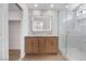 Modern bathroom featuring marble accents, a dual-sink vanity, and a glass-enclosed shower at 6405 Strongbow Dr, Las Vegas, NV 89156