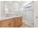 Elegant bathroom featuring marble walk-in shower, dual-sink vanity, and a large, illuminated mirror at 6405 Strongbow Dr, Las Vegas, NV 89156