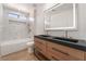 A luxurious bathroom with a bathtub and standing shower, also featuring a double sink vanity at 6405 Strongbow Dr, Las Vegas, NV 89156