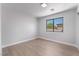 A minimalist-style room with a black framed window and light-colored floors at 6405 Strongbow Dr, Las Vegas, NV 89156