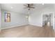 A bright room with two windows and an open hallway in a modern style home at 6405 Strongbow Dr, Las Vegas, NV 89156