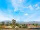 Enjoy panoramic city views with palm trees, rooftops, and mountain silhouettes under a blue sky at 6405 Strongbow Dr, Las Vegas, NV 89156