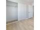 A walk-in closet with sliding doors and wood flooring at 6405 Strongbow Dr, Las Vegas, NV 89156