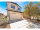 Two-story home featuring shuttered windows, desert landscaping and a two car garage at 6405 Strongbow Dr, Las Vegas, NV 89156