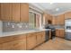 Well-lit kitchen with wood cabinets, stainless steel appliances, and light countertops at 6405 Strongbow Dr, Las Vegas, NV 89156
