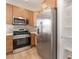Close up view of the kitchen with stainless steel appliances and pantry access at 6405 Strongbow Dr, Las Vegas, NV 89156
