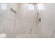 Shower with modern tile, shower head, and built in shelves at 6405 Strongbow Dr, Las Vegas, NV 89156