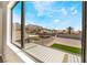 View of the backyard with artificial turf and gravel landscaping, as seen from inside the home at 6405 Strongbow Dr, Las Vegas, NV 89156