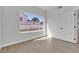 Bedroom with new floors and a window with a view of the neighborhood at 6509 Old Oxford Ave, Las Vegas, NV 89108