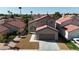Inviting single-Gathering home featuring a well-manicured lawn, two-car garage, and classic architecture at 6509 Old Oxford Ave, Las Vegas, NV 89108