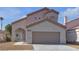 Inviting two-story home with a well-manicured lawn, a two-car garage, and desert landscaping at 6509 Old Oxford Ave, Las Vegas, NV 89108