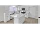 Bright kitchen with an island, white cabinetry, modern appliances, and sleek countertops at 6509 Old Oxford Ave, Las Vegas, NV 89108
